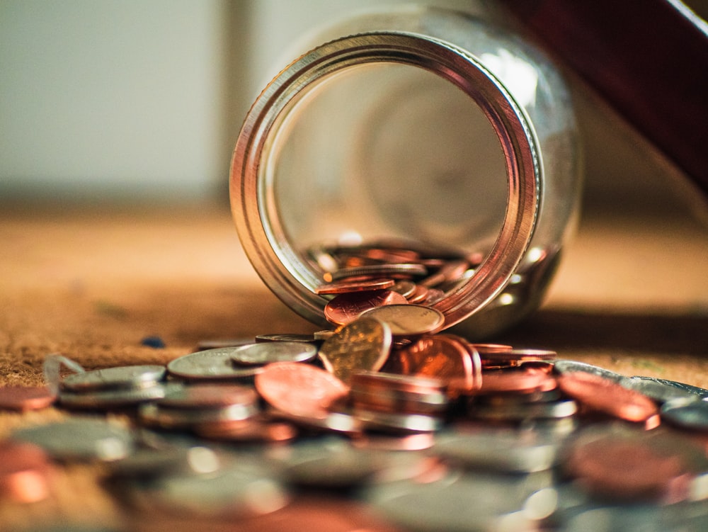 Jar with Money Falling Out of It